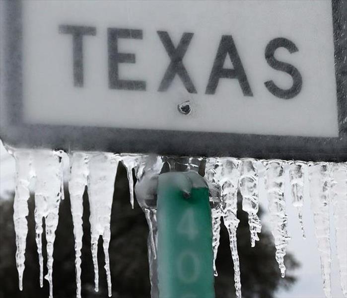 A frozen road sign that says Texas. SERVPRO is here to help with any water remediation and removal.