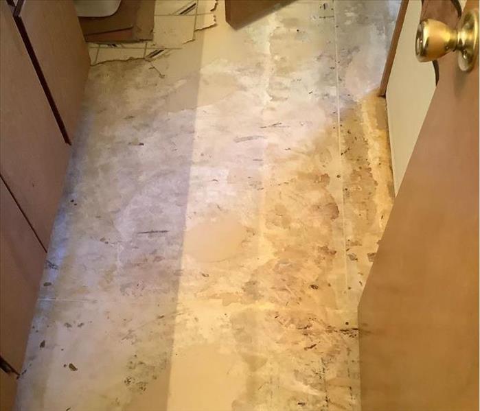A bathroom in Flagstaff, AZ, after the flooring was removed so that the room could be dried out following a leak.